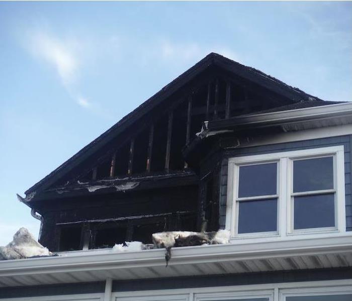 Home with visible fire damage on the upper floor
