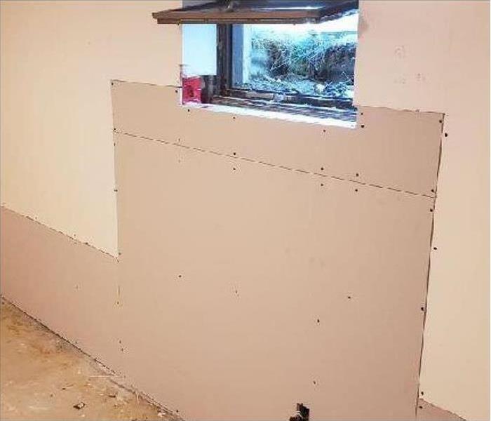 Wall with new drywall in under a window
